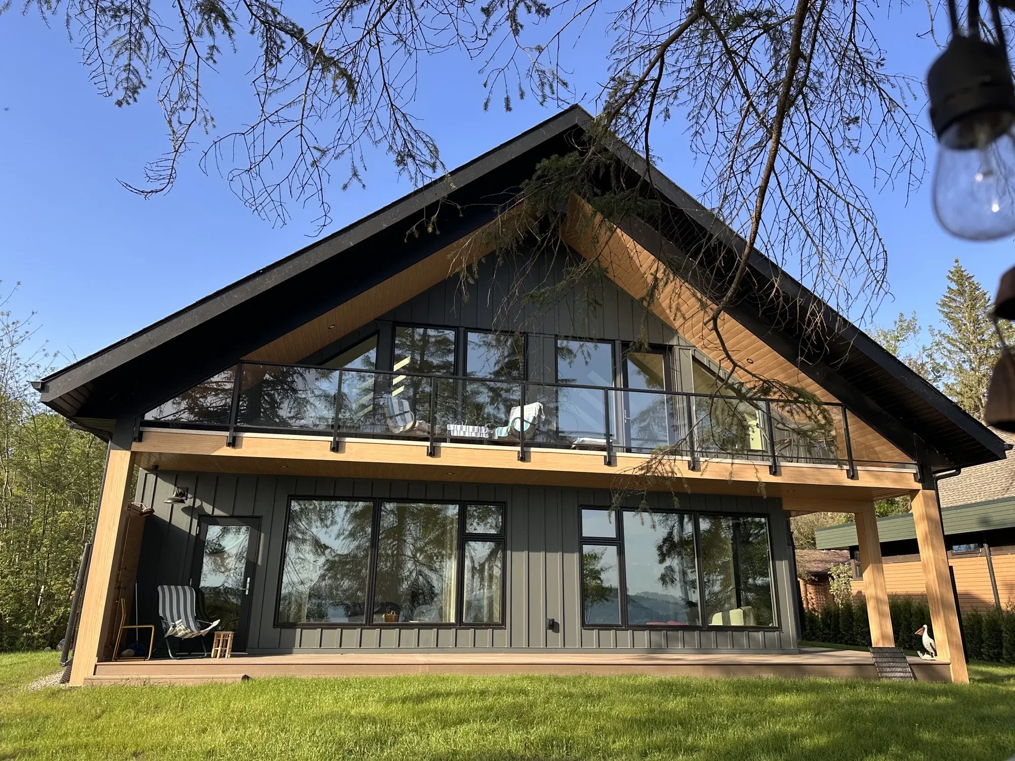 Premium exterior home finishing in Central Alberta — James Hardie siding, steel roofing, and a Wizard motorized screen room by PJM Home Advantage