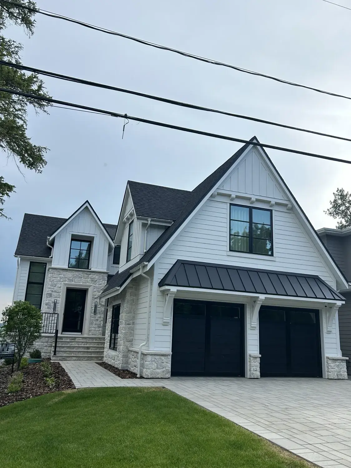White modern farmhouse new build with exterior finishing by PJM Home Advantage in Central Alberta